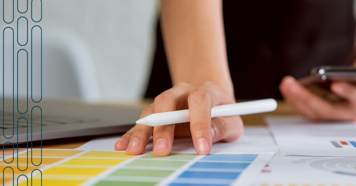 woman's hand with pen planning content charts